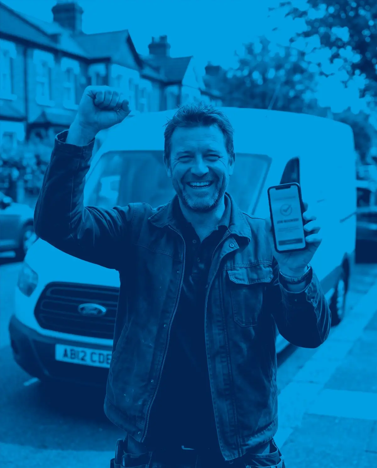 A delighted builder by his van, celebrating a newly booked job
